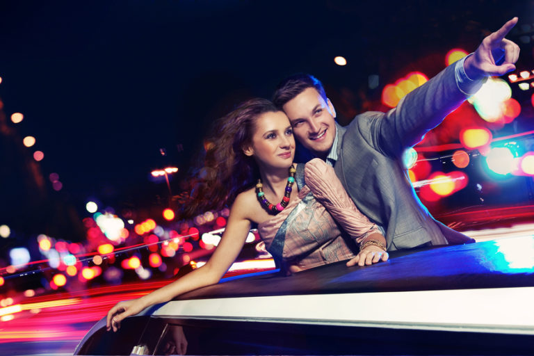 Elegant couple traveling a limousine at night